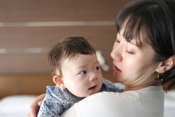 istock Mother holding her baby 1334261820