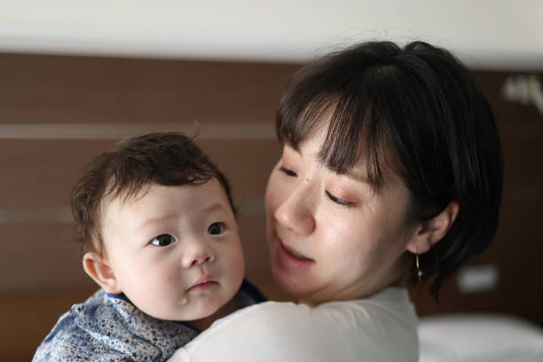 istock Mother holding her baby 1334262027