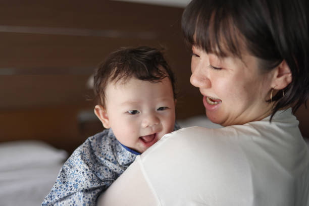 istock Mother holding her baby 1334262053