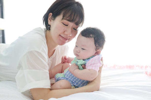 istock Mother singing lullaby for her bay to sleep 1334262086