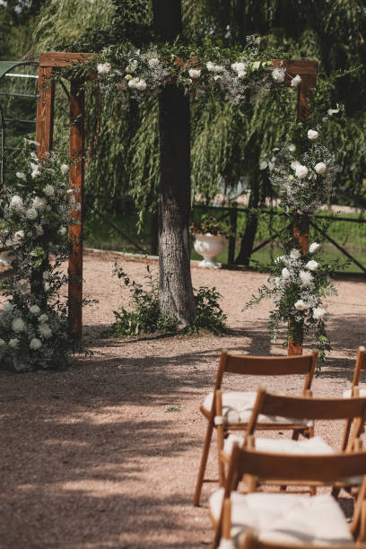 istock Wedding arch on boho style with white flowers in park. 1334267213