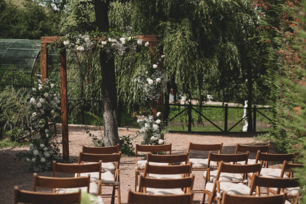 istock Wedding arch on boho style with white flowers in park. 1334267599
