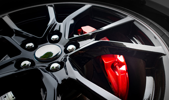 Modern light alloy wheel with red brake cylinder visible behind the rim