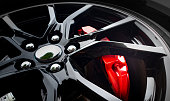 istock Modern light alloy wheel with red brake cylinder visible behind the rim 1334268665