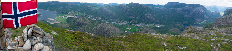 Norwegian flag with a Dramatic aerial view of lake town and fjords in background. Top of Fjords in Southern Norway - European Hiking and travel Concept