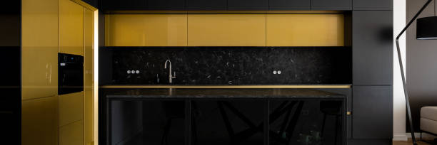 istock Luxury kitchen in black and gold, panorama 1334271015