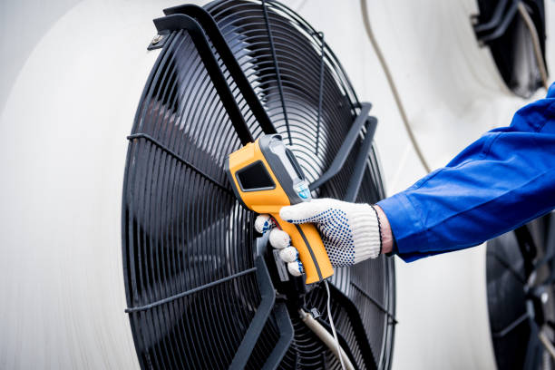 istock Technician uses a thermal imaging infrared thermometer to check the condensing unit heat exchanger. 1334272551