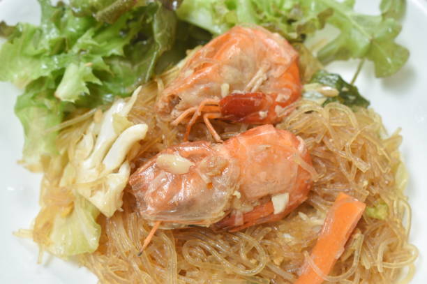 fried glass noodles with shrimp and cabbage with egg on plate