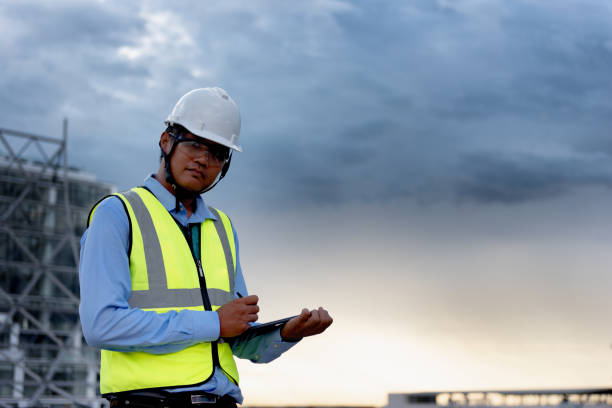 istock Engineering Consulting on construction site holding tablet in his hand with copy space. Management in business workflow and Building inspector with technology in Construction Project. 1334272870
