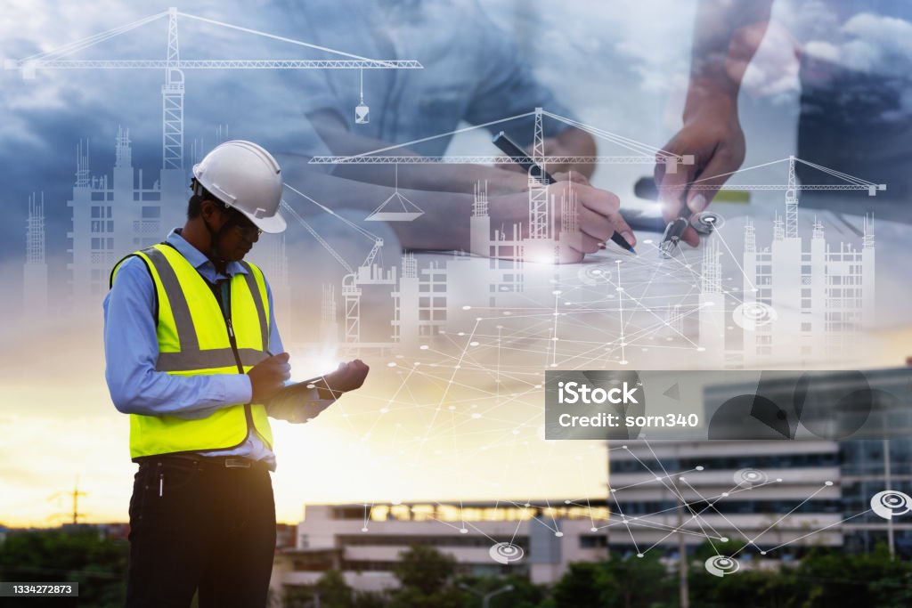 Engineering Consulting People on construction site holding tablet in his hand. Management in business workflow and Building inspector with BIM technology in Construction Project. Construction Industry Stock Photo