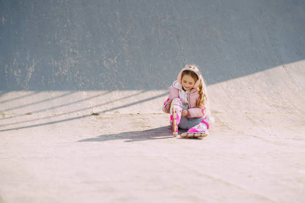 istock Mother with daughter in a spring park with rollers 1334273860