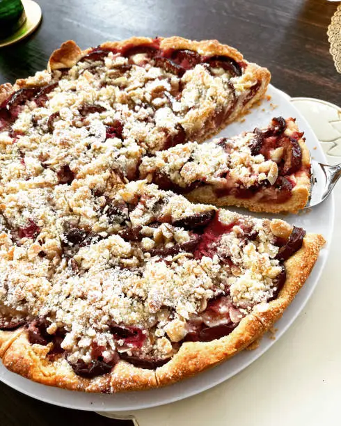 close-up of fresh baked german plum cake with crumbles