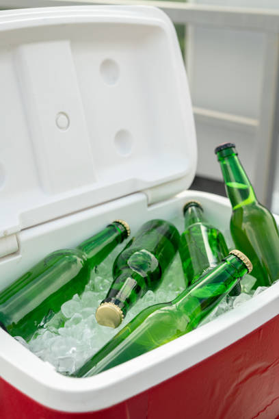 istock Several green bottles of beer in box with ice cubes 1334276927