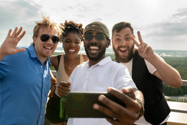 istock Cheerful intercultural friends making selfie outdoors 1334277573