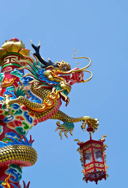 istock Dragon statue and blue sky background 1334279198