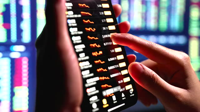 Stock Exchange, Trading Online, Trader Working With Smartphone on Stock Market Trading Floor