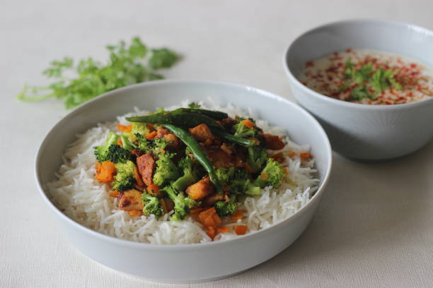 istock Cooked basmati rice mixed with sauteed carrots, broccoli and chicken Served with masala curd 1334281493
