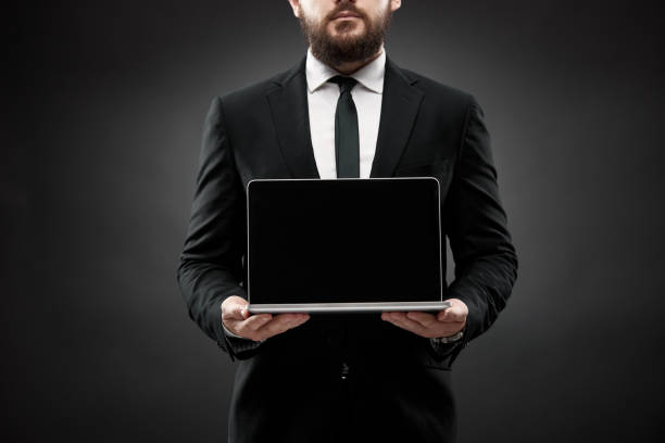 istock Businessman showing open laptop screen 1334281811