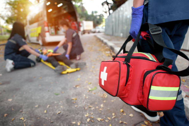 Emergency Medical First aid kit bags of first aid team service for an accident in work of worker loss of function in limbs, First aid training to transfer patient stock photo