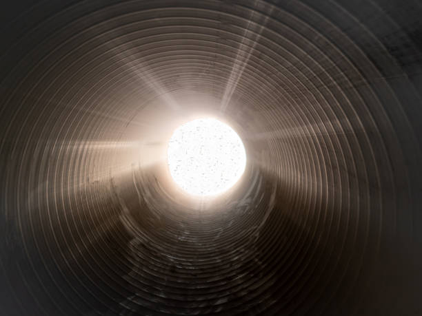istock The sun's rays shine at the end of a large pipe. 1334283742
