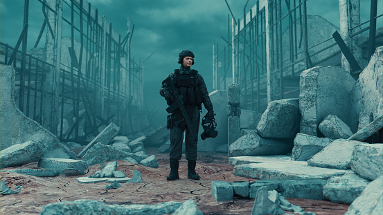 Soldier with a rifle takes a break while standing in a warzone. He holds a face mask in his hand. Digitally generated image.