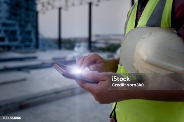 Engineering Consulting People On Construction Site Holding Tablet In His Hand Management In Business Workflow And Building Inspector With Bim Technology In Construction Project Stock Photo - Download Image Now