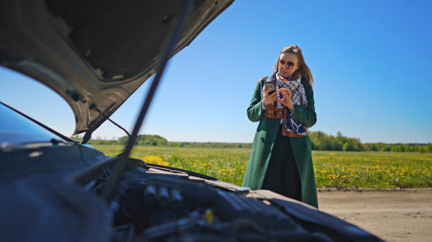 istock Woman near broken car calling for help. 1334284200