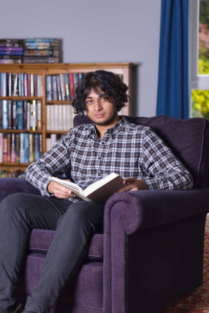 istock Young South Asian man reading in his study 1334286478