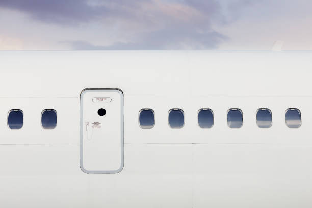 Fuselage of airplane against moody sky Fuselage of airplane with door and windows. Plane against moody sky. vehicle door stock pictures, royalty-free photos & images