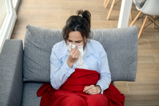 istock Young woman blowing a nose 1334287514