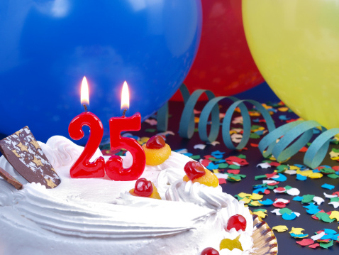 25th. Anniversary / Birthday cake in a Party background with balloons and party strings.