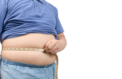 obeso gordo chico cinta métrica de estómago aislado en blanco photo