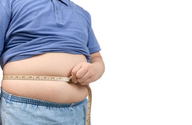 obese fat boy measuring tape of stomach isolated on white obese fat boy measuring tape of stomach isolated on white  background, healthy and lose weight concept stout stock pictures, royalty-free photos & images