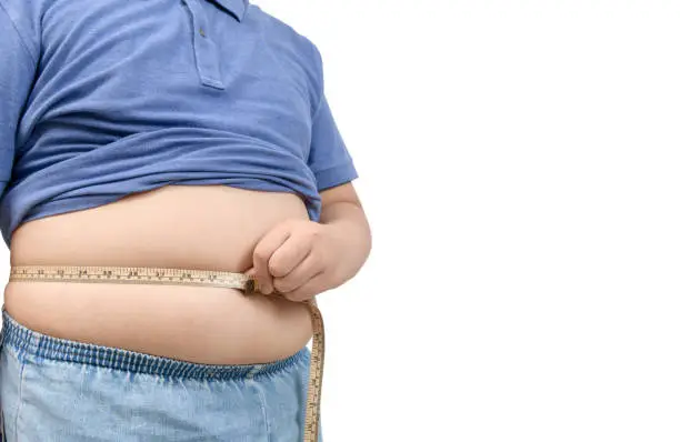 Photo of obese fat boy measuring tape of stomach isolated on white