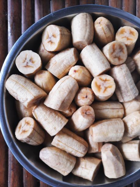istock Banana pieces in bowl - Thai dessert cooking preparation. 1334289749