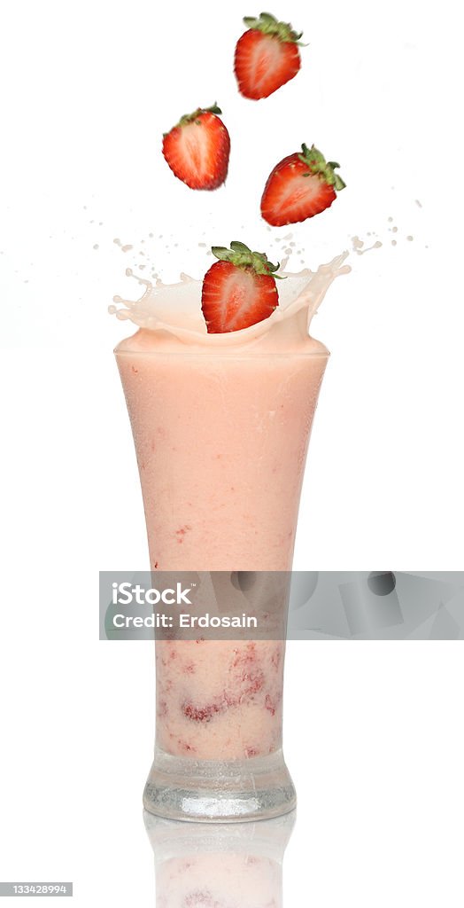 Strawberry smoothie with splash Strawberries splashing into a milkshake Drinking Glass Stock Photo