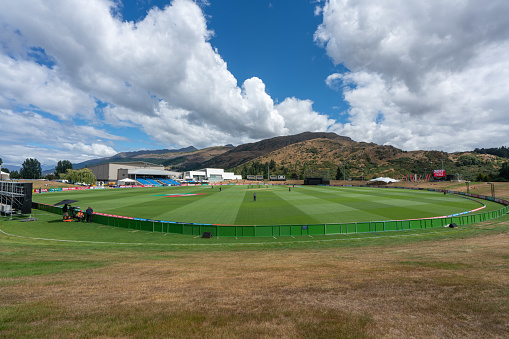 Queenstown, New Zealand - Jan 18, 2018: Cricket stadium with competion and large hill in the back