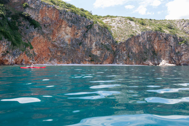istock Woman paddling under the cliffs 1334292328