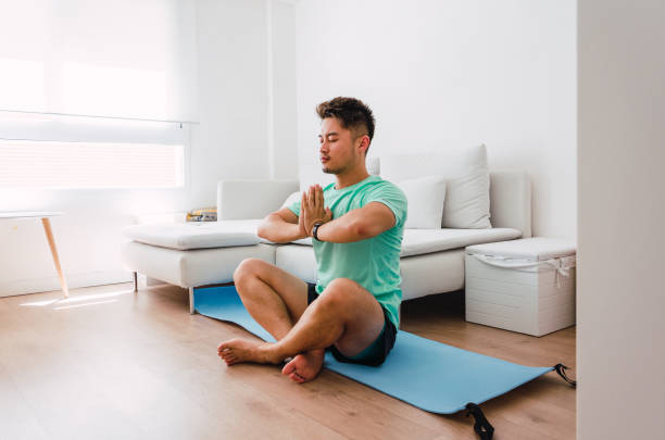 istock Asian practising yoga at home 1334295635