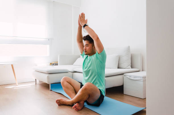 istock Asian practising yoga at home 1334295644