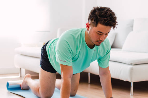istock Asian practising yoga at home 1334295652