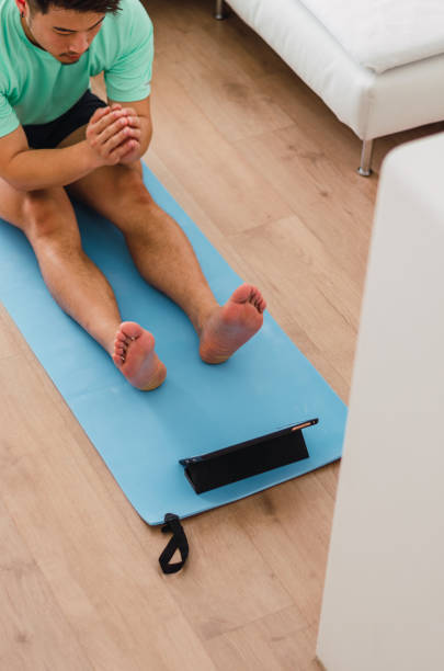 istock Asian practising yoga at home 1334295670