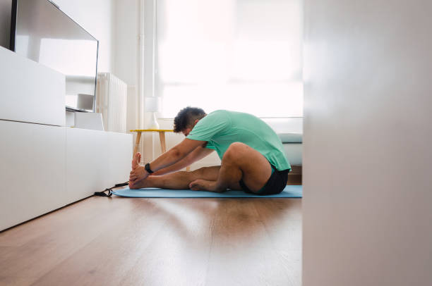 istock Asian practising yoga at home 1334295710