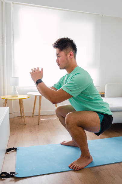 istock Asian practising yoga at home 1334295738