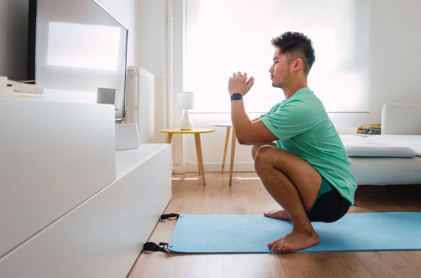 istock Asian practising yoga at home 1334295741