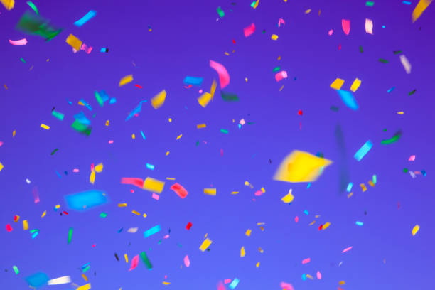 istock multicolored confetti on ultra violet background. Concept of hol 1334297328