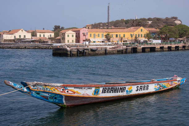 Dakar, Senegal - May 27, 2014: Strikingly decorated fishing boat moored in the bay and harbor of Goree Island