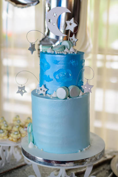 istock Blue birthday cake with macaroons and stars on candy bar 1334299499