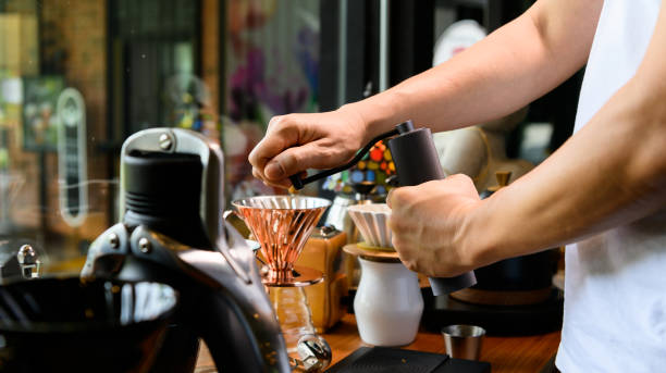 istock Barista grinding coffee beans for drip brew 1334299696