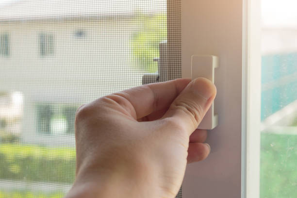 istock Hand hold mosquito net wire screen handle on house window 1334302309